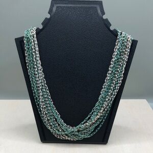 Multi chain mixed metal color link trendy layered statement style necklace.